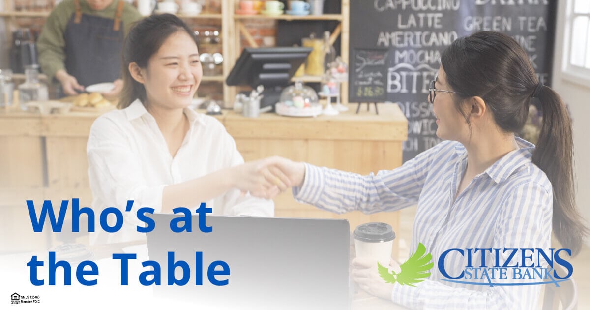 two women shaking hands in a restaurant with text