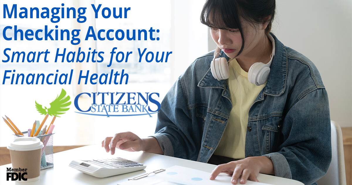 young woman using a calculator to check her checking account math